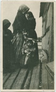 Woman with infant laced in cradle