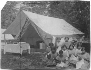 Girls of the Elizabeth Long Memorial Home sewing at camp